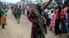 FILE - A Congolese army soldier responds to cheers from civilians as the army enters the town of Bunagana, eastern Congo, near the border with Uganda, Oct. 30, 2013. 