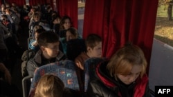 Children ride on a bus during their evacuation to western Ukraine, from the southern city of Kherson, on Oct. 30, 2023, amid the Russian invasion of Ukraine.
