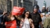 FILE - Policemen detain demonstrators during a protest in Moscow, Russia, May 5, 2018. The posters reads "I am against corruption."