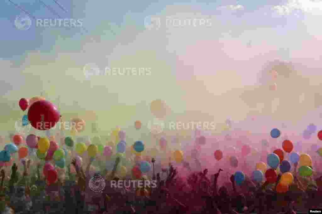 Participants throw colored powders as they take part in the Color Run in the Andalusian capital of Seville, Spain. The Color Run is a five-kilometer race, held in cities across the U.S. and world, to promote healthy living, and to benefit a charity chosen by the race&#39;s local organizers. 