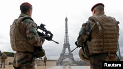 FILE - French army paratroopers patrol near the Eiffel tower in Paris, France, March 30, 2016. French authorities are extending a state-of-emergency they imposed after the November 2015 terror attacks that killed 130 people.