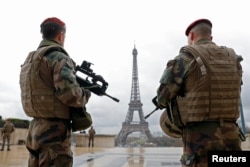 FILE - French army paratroopers patrol near the Eiffel tower in Paris, France, March 30, 2016.