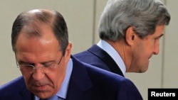 U.S. Secretary of State John Kerry (R) walks behind Russian Foreign Minister Sergei Lavrov (L) at the start of a NATO-Russia foreign ministers meeting in Brussels April 23, 2013.