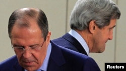 U.S. Secretary of State John Kerry (R) walks behind Russian Foreign Minister Sergei Lavrov (L) at the start of a NATO-Russia foreign ministers meeting in Brussels, April 23, 2013.