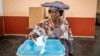 A woman casts her vote at a polling station in Windhoek, Namibia, during extended voting following the country's general election.