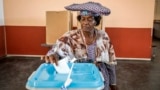 A woman casts her vote at a polling station in Windhoek, Namibia, during extended voting following the country's general election.