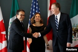 Mexico's Economy Minister Ildefonso Guajardo, left, shakes hands with U.S. Trade Representative Robert Lighthizer before the start of a trilateral meeting with Canada's Foreign Minister Chrystia Freeland during the third round of NAFTA talks in Ottawa, Ontario, Sept. 27, 2017.