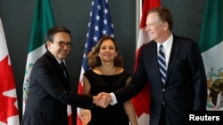 FILE - Mexico's Economy Minister Ildefonso Guajardo, left, shakes hands with U.S. Trade Representative Robert Lighthizer before the start of a trilateral meeting with Canada's Foreign Minister Chrystia Freeland during the third round of NAFTA talks in Ottawa, Ontario, Sept. 27, 2017. Some participants in the latest round, being held in Arlington, Va., said U.S. demands have increased the odds of NAFTA's demise.