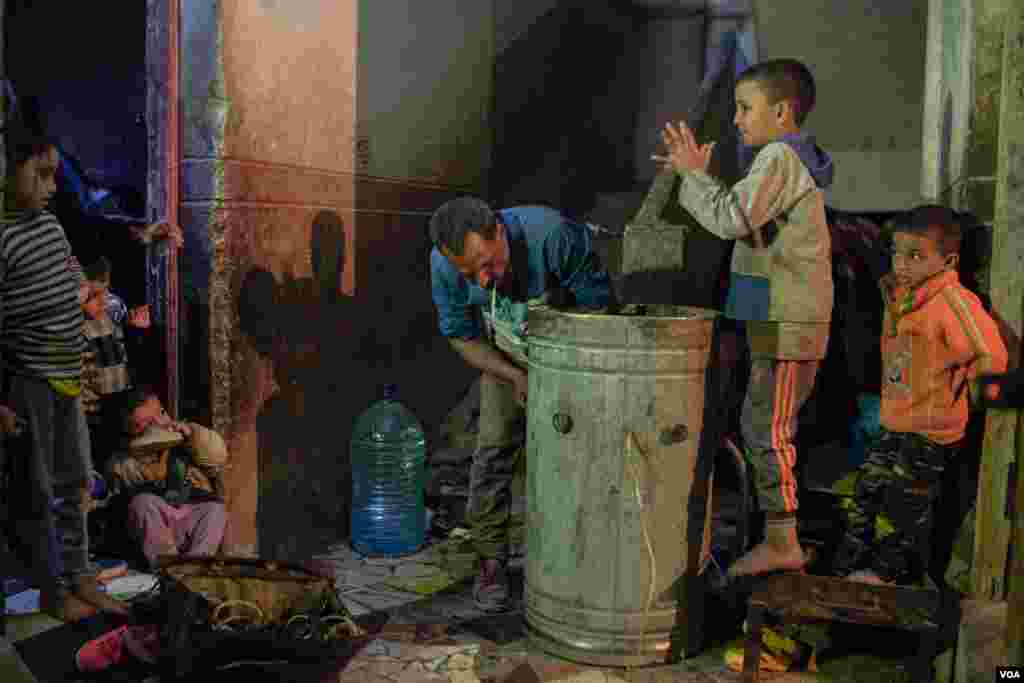 Children enjoy watching Abdallah while he works. (Hamada Elrasam/VOA)