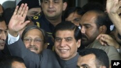 Pakistan's Prime Minister Raja Pervaiz Ashraf waves upon arriving at the Supreme Court for a hearing where he will submit his reply regarding the court's order to reopen an old corruption case against the country's president, in Islamabad, Pakistan, Sept.