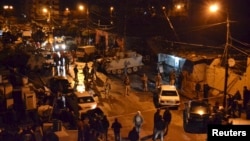 Lebanese Army soldiers man an area beside a cafe where a suicide bomb attack took place in Jabal Mohsen, Tripoli, Jan. 10, 2015.