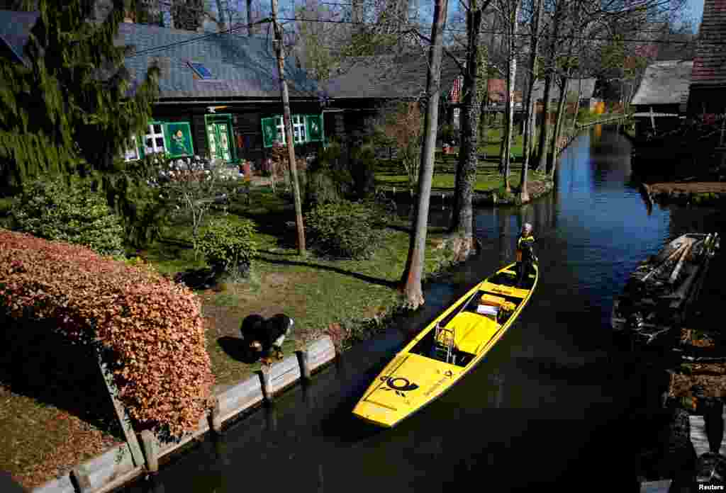 Deutsche Post DHL postwoman Andrea Bunar delivers mail using a traditional boat in the Spreewald village of Lehde, Germany. Bunar is the country&#39;s only postwoman to deliver the mail by boat in the village from April until October.