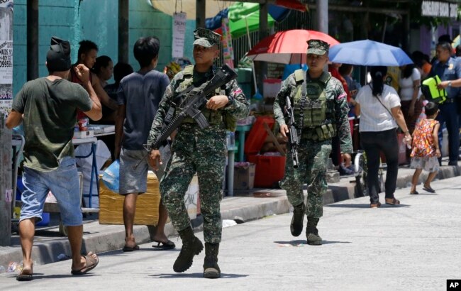Philippine Marines secure a polling center during the country's midterm elections in Manila, Philippines on Monday, May 13, 2019.