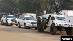 FILE - U.N. peacekeepers take a break as they patrol a street during the presidential election in Bangui, the capital of Central African Republic, Dec. 30, 2015. The peacekeepers have been deployed recently to villages outside the capital to prevent violence from spreading.