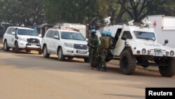 FILE - U.N. peacekeepers take a break as they patrol along a street during the presidential election in Bangui, the capital of Central African Republic, Dec. 30, 2015. 