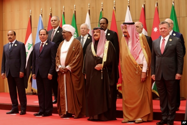 A section of twenty one kings, presidents and top officials from the Arab League summit pose for a group photo, at a gathering near the Dead Sea in Jordan, March 29, 2017.