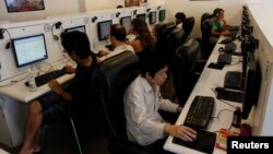 FILE - People surf the web at an Internet cafe which in Bangkok.