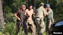 Turkish soldiers detain Staff Sergeant Erkan Cikat, suspected of being involved in the recent coup attempt, in Marmaris, Turkey, July 25, 2016.