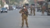 A Myanmar soldier stands guard on a road amid demonstrations against the military coup in Naypyidaw on February 17, 2021. (Photo by STR / AFP)