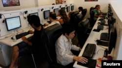 FILE - People surf the web at an Internet cafe which in Bangkok, Sept. 29, 2010.