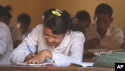 A girl sits in a history class at the local high school in Kampong Trach, Cambodia.