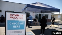 FILE - People arrive for coronavirus vaccinations, at East Valley Community Health Center in La Puente, California, March 5, 2021. 