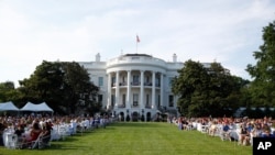 Guests wait for President Donald Trump and first lady Melania Trump during a "Salute to America" event on the South Lawn of the White House, July 4, 2020, in Washington. 