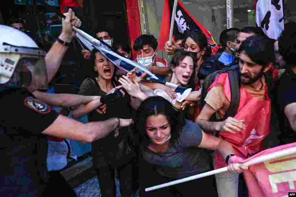 Protesters clash with police officers during a rally in the Kadikoy district in Istanbul, July 20, 2021, called to mark the anniversary of the 2015 suicide attack that took place in the southern Turkish town of Suruc.