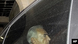 Former IMF chief Dominique Strauss-Kahn leaves his home on his way to a police station to confront a writer who accuses him of attempted rape, in Paris, France, Sept. 29, 2011.