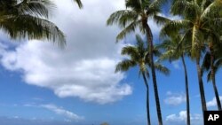 A man walks along a closed pier on Waikiki Beach in Honolulu on March 28, 2020.