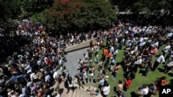 People take part in a prayer vigil at Thanksgiving Square, July 8, 2016, in Dallas.