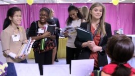 Martina Ryberg, right, of Plymouth State University talks with Tara Rossetti of On Call International during a 2012 job-finding event for college students in Manchester, New Hampshire.