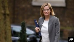 FILE - Amber Rudd, Britain's Home Secretary, arrives for a cabinet meeting at Downing Street, London, March 29, 2017.
