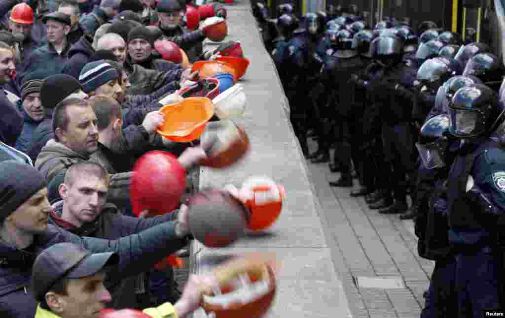 Ukrainian coal miners protest outside the government building in Kyiv, demanding the government protect their jobs as the eastern separatist conflict threatens to force pits to close. Banging their helmets, the miners yelled &quot;Shame&quot; on the pro-western government, demanding it raise their pay and restore subsidies to the mines that help power the Ukrainian industry. &nbsp;
