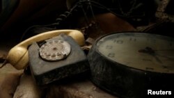 A rotary dial telephone set and clock are seen in the NATO tunnels dating back to the Cold War in the War Headquarters tunnels beneath Valletta, Malta, March 28, 2017.