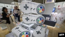 This photo taken on September 24, 2024, shows large console-shaped pillows in the gift shop during a media preview of the new Nintendo Museum, located inside a renovated old factory, in the suburbs of Kyoto. (Photo by Richard A. Brooks / AFP)