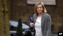 FILE - Amber Rudd, Britain's home secretary, arrives for a cabinet meeting at Downing Street, London, March 29, 2017.