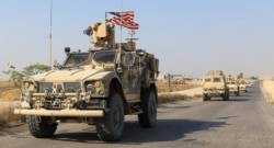 FILE - A convoy of U.S. vehicles is seen after withdrawing from northern Syria, on the outskirts of Dohuk, Iraq, Oct. 21, 2019.