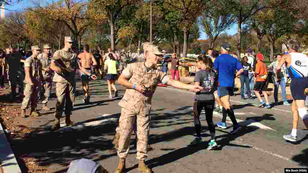 Marines hand out Jelly Belly Sports Beans near the mile 19 mark of the Marine Corps Marathon on Sunday in Washington, D.C.