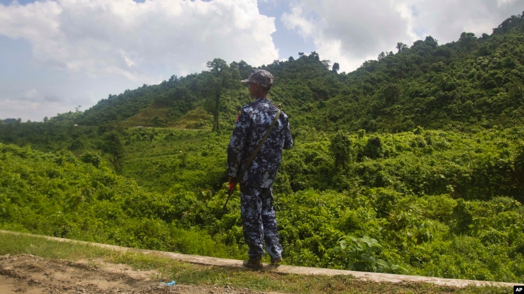 FILE - A Myanmar police officer stands on a road checkpoint in Buthidaung, Rakhine state, on May 28, 2017. The U.N. human rights office warned on May 24, 2024, of “frightening and disturbing reports” of violence against the Rohingya people in Myanmar's Rakhine state. 