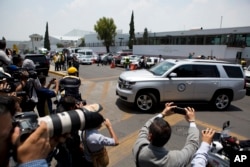 Journalists take pictures as a convoy carrying former Veracruz state Governor Javier Duarte exits the hangar of the attorney general's office at the Mexico City airport after Duarte arrived from Guatemala, July 17, 2017.