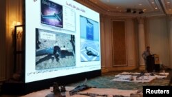FILE - Saudi-led coalition spokesman, Colonel Turki al-Malki, displays Iran-aligned Houthi drones, brought down over Jizan and Abha, during a news conference in Khobar, Saudi Arabia, Apr, 16, 2018. 