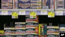 FILE - Packages of aspirin fill the shelves of a drugstore, Aug. 11, 2009.