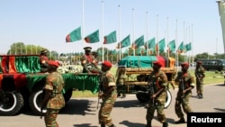 FILE: Flags fly at half mast as the funeral cortege for the late Zambian President Michael Sata arrives for a memorial service in the capital Lusaka, Zambia, Nov. 10, 2014.