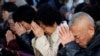 FILE - Believers take part in a weekend mass at an underground Catholic church in Tianjin.