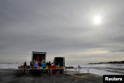 Volunteers and staff of Gather food pantry set up as they prepare to distribute food to members of the U.S. Coast Guard, who are working without pay during the government shutdown, at the U.S. Coast Guard Portsmouth Harbor base in New Castle, N.H., Jan. 23, 2019.