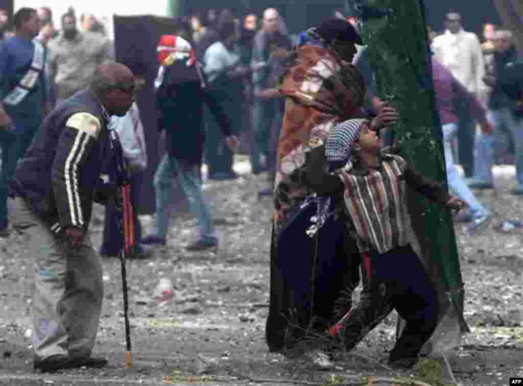 Egyptian protesters throw rocks at military police during clashes near Cairo's downtown Tahrir Square, Egypt, Friday, Dec. 16, 2011. Activists say the clashes began after soldiers severely beat a young man who was part of a sit-in protest outside the Cab