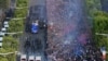 Fans greet France&#39;s national football team players as they celebrate on the roof of a bus while they parade down the Champs-Elysee avenue in Paris, after winning the Russia 2018 World Cup final football match.