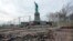 FILE - The Statue of Liberty stands beyond parts of a brick walkway damaged in Superstorm Sandy on Liberty Island in New York, Nov. 30, 2012. With scientists forecasting sea levels to rise by anywhere from several inches to several feet by 2100, historic structures and coastal heritage sites around the world are under threat. 