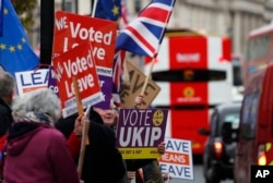 FILE - Brexit supporters protest opposite the Houses of Parliament in London, Britain, Jan. 15, 2019.